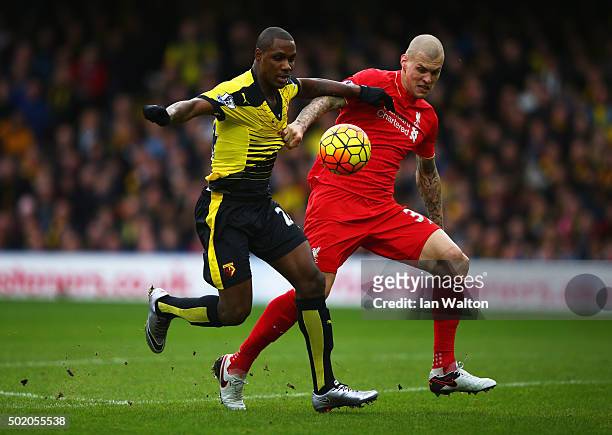 Odion Ighalo of Watford holds off Martin Skrtel of Liverpool as he scores their second goal during the Barclays Premier League match between Watford...