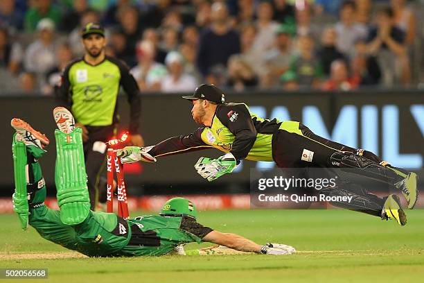 Chris Hartley of the Thunder attempts to run out James Faulkner of the Stars during the Big Bash League match between Melbourne Stars and Sydney...