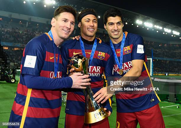 Lionel Messi, Neymar and Luis Suarez of Barcelona hold the Winner's Trophy after the FIFA Club World Cup Japan 2015 Final between River Plate and FC...