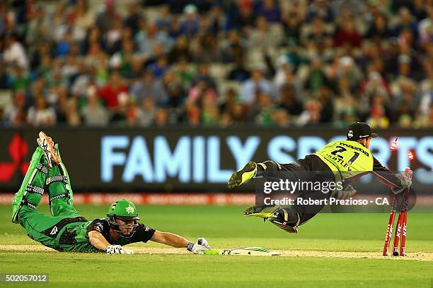 Chris Hartley of the thunder attempts to run out James Faulkner of the stars during the Big Bash League match between Melbourne Stars and Sydney...