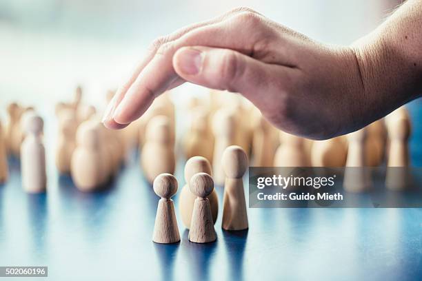 hand over symbolic pawn family. - protection stockfoto's en -beelden