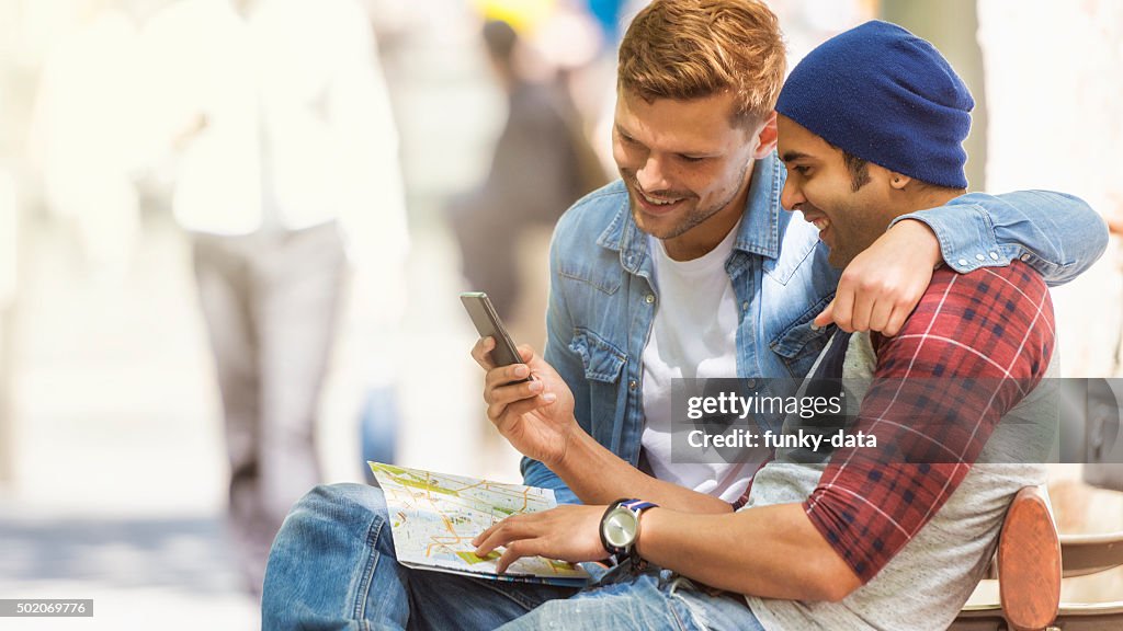 Friends using map during city trip