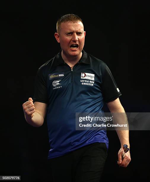 Joe Murnan of England celebrates winning his first round match against Andy Hamilton of England during the 2016 William Hill PDC World Darts...