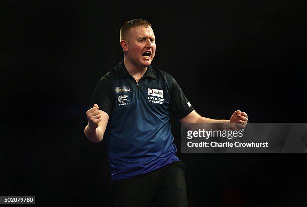 Joe Murnan of England celebrates winning his first round match against Andy Hamilton of England during the 2016 William Hill PDC World Darts...