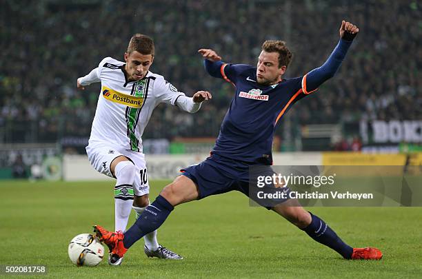 Thorgan Hazard of Borussia Moenchengladbach and Philipp Bargfrede of Werder Bremen battle for the ball during the DFB-Cup match between Borussia...