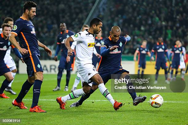 Raffael of Borussia Moenchengladbach and Theodor Grebe Selassie of Werder Bremen battle for the ball during the DFB-Cup match between Borussia...