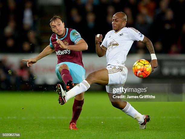 Mark Noble of West Ham United in action with Swansea's Andre Ayew during the Barclays Premier League match between Swansea City and West Ham United...