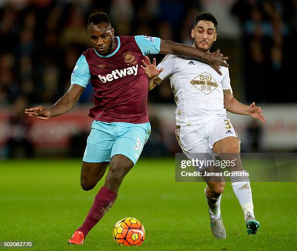 Michail Antonio of West Ham United in action with Swansea's Neil Taylor during the Barclays Premier League match between Swansea City and West Ham...