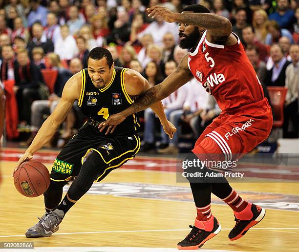 David McCray of Ludwigsburg is challenged by Kelvin Rivers of Bayern Muenchen during the Basketball match between FC Bayern Muenchen and MHP RIESEN...