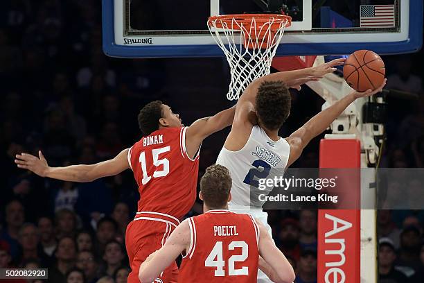 Lorenzo Bonam of the Utah Utes defends a shot by Chase Jeter of the Duke Blue Devils during the Ameritas Insurance Classic at Madison Square Garden...