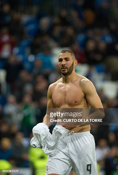 Real Madrid's French forward Karim Benzema runs without his t-shirt after the Spanish league football match Real Madrid CF vs Rayo Vallecano de...