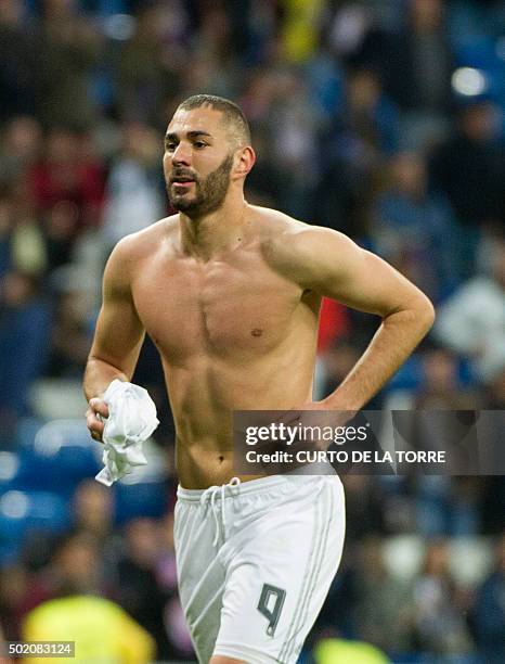 Real Madrid's French forward Karim Benzema runs without his t-shirt after the Spanish league football match Real Madrid CF vs Rayo Vallecano de...