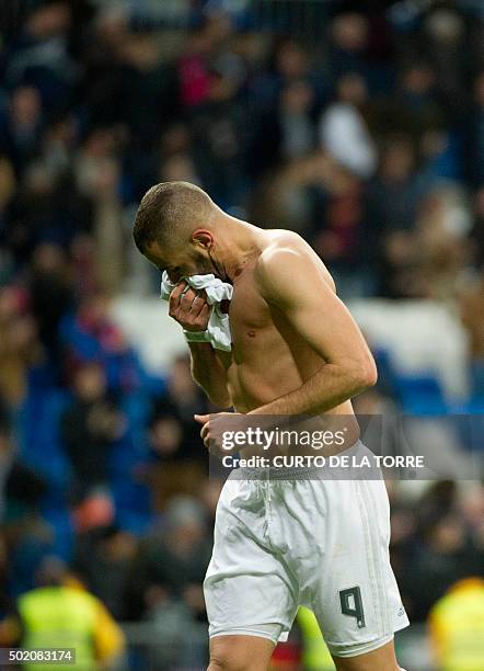 Real Madrid's French forward Karim Benzema runs without his t-shirt after the Spanish league football match Real Madrid CF vs Rayo Vallecano de...