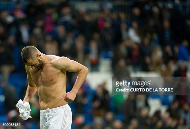 Real Madrid's French forward Karim Benzema runs without his t-shirt after the Spanish league football match Real Madrid CF vs Rayo Vallecano de...