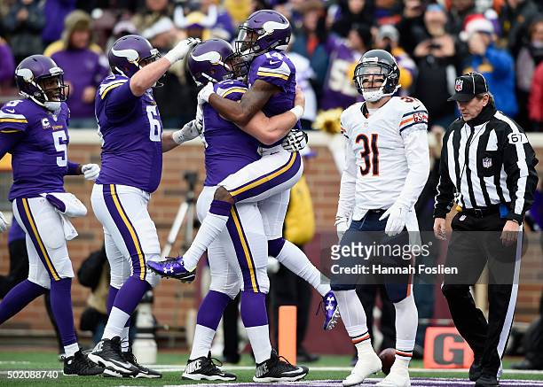 The Minnesota Vikings celebrate a touchdown by Stefon Diggs as Chris Prosinski of the Chicago Bears looks on during the first quarter of the game on...