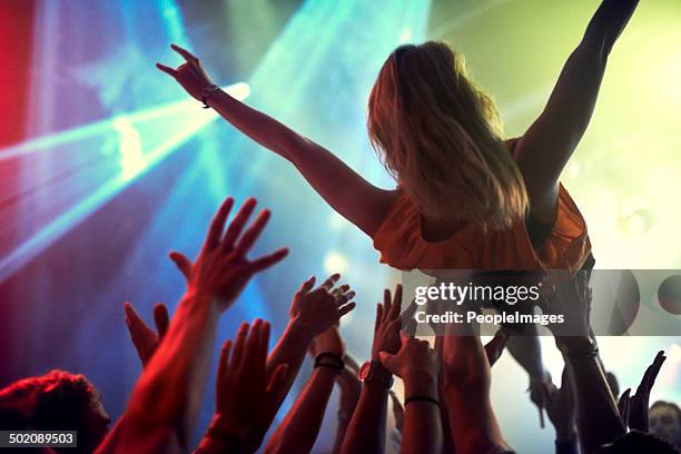 the only way to feel at one with an audience - crowdsurfing stockfoto's en -beelden