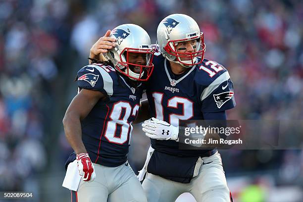 Tom Brady of the New England Patriots celebrates with Keshawn Martin after throwing a touchdown pass to James White during the second quarter against...