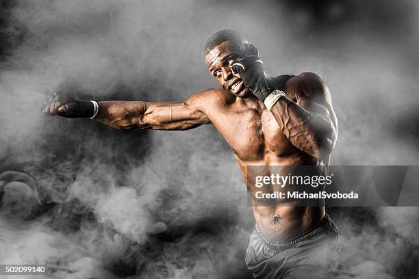 mma fighter on a smokey  background - mma fighter stock pictures, royalty-free photos & images