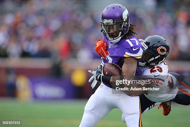 Jarius Wright of the Minnesota Vikings carries the ball for a gain and a first down while Kyle Fuller of the Chicago Bears makes the tackle in the...