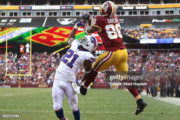 Wide receiver Pierre Garcon of the Washington Redskins scores a fourth quarter touchdown past strong safety Leodis McKelvin of the Buffalo Bills at...