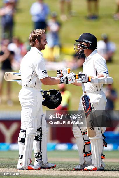 Kane Williamson of New Zealand is congratulated by BJ Watling as he makes a century during day four of the Second Test match between New Zealand and...