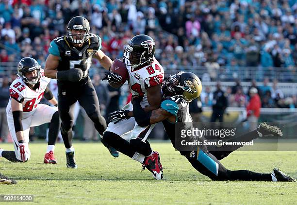 Roddy White of the Atlanta Falcons is tackled by Nick Marshall of the Jacksonville Jaguars during the game at EverBank Field on December 20, 2015 in...