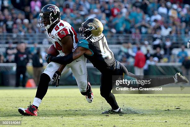 Roddy White of the Atlanta Falcons is tackled by Nick Marshall of the Jacksonville Jaguars during the game at EverBank Field on December 20, 2015 in...