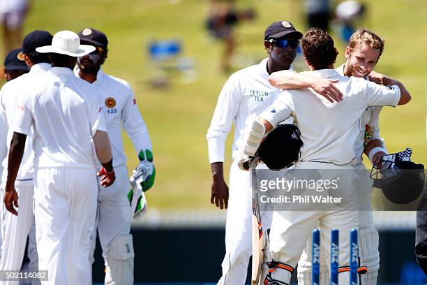 Watling and Kane Williamson of New Zealand embrace at the end of day four of the Second Test match between New Zealand and Sri Lanka at Seddon Park...