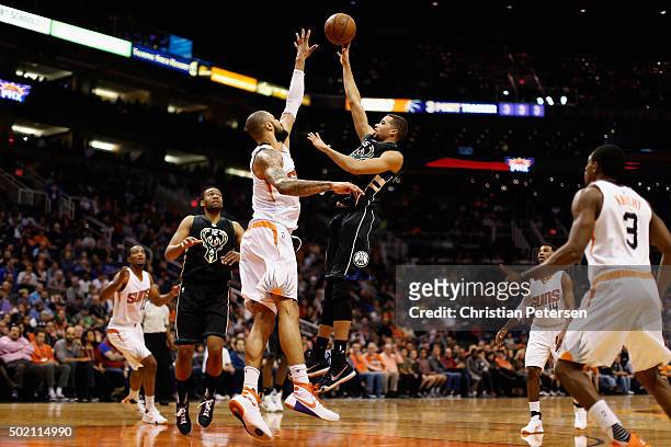 Michael Carter-Williams of the Milwaukee Bucks puts up a shot over Tyson Chandler of the Phoenix Suns during the first half of the NBA game at...