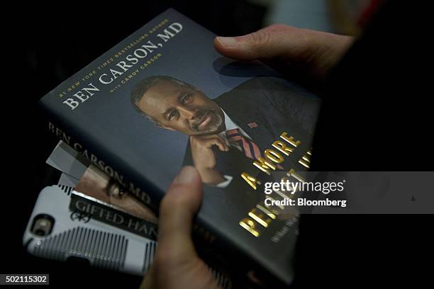 Supporter holds books by Ben Carson, retired neurosurgeon and 2016 Republican presidential candidate, to be signed after Carson spoke at a town hall...