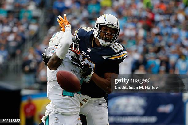 Malcom Floyd of the San Diego Chargers is defended by Brice McCain of the Miami Dolphins at Qualcomm Stadium on December 20, 2015 in San Diego,...