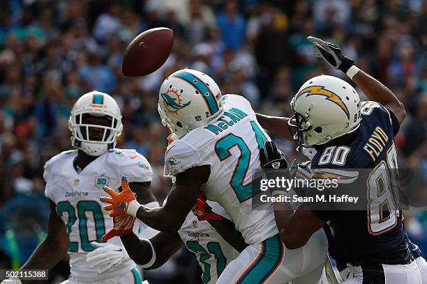 Brice McCain of the Miami Dolphins breaks up a San Diego Chargers pass attempt that is intercepted by Reshad Jones of the Miami Dolphins at Qualcomm...