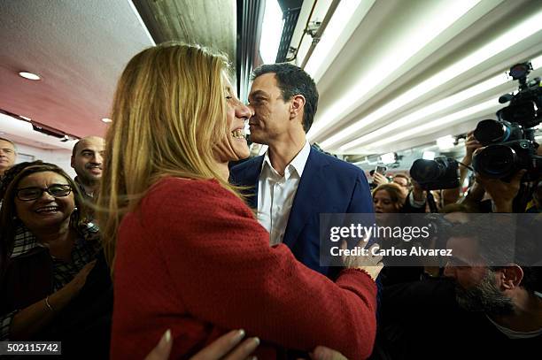 Leader of Spain's Socialist Party and candidate for general elections Pedro Sanchez and his wife Begona Fernandez greet supporters after the first...