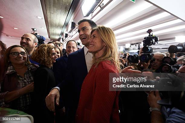 Leader of Spain's Socialist Party and candidate for general elections Pedro Sanchez and his wife Begona Fernandez greet supporters after the first...