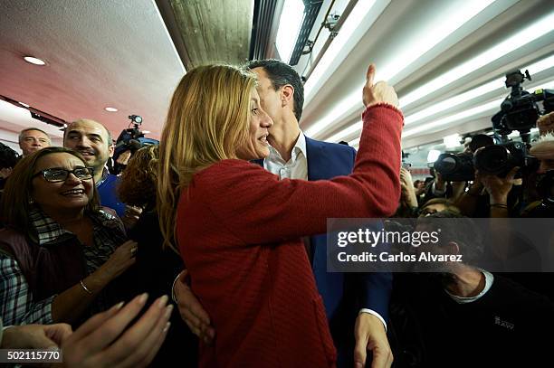 Leader of Spain's Socialist Party and candidate for general elections Pedro Sanchez and his wife Begona Fernandez greet supporters after the first...