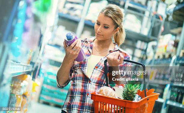 woman buying food in supermarket. - convenience basket stock pictures, royalty-free photos & images