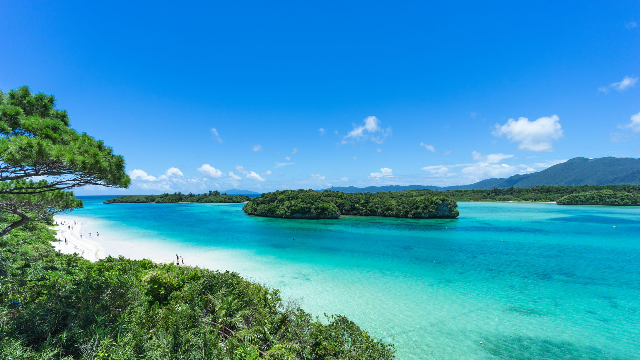 Tropical beach, clear blue lagoon and rock islands, Okinawa, Japan Tropical beach, clear blue lagoon and rock islands, Okinawa, Japan