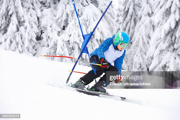 giant slalom race  a young boy teenager  snow skier skiing - slalom stockfoto's en -beelden