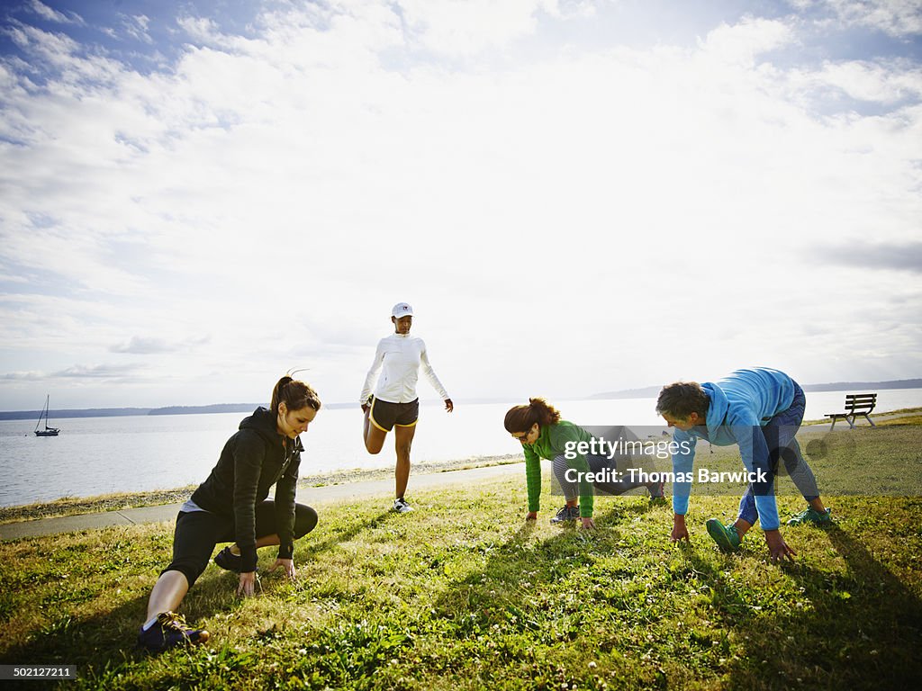 Group of female friends stretching before run