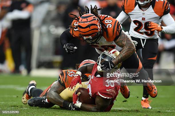 Kendall Gaskins of the San Francisco 49ers is tackled by Vontaze Burfict and Rey Maualuga of the Cincinnati Bengals during their NFL game at Levi's...