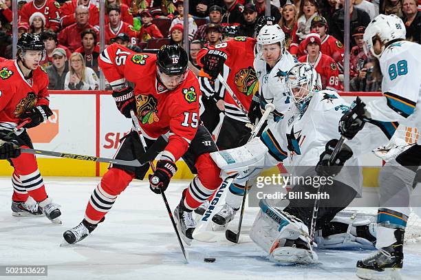 Artem Anisimov of the Chicago Blackhawks approaches the puck to shoot and score on goalie Martin Jones of the San Jose Sharks in the first period of...