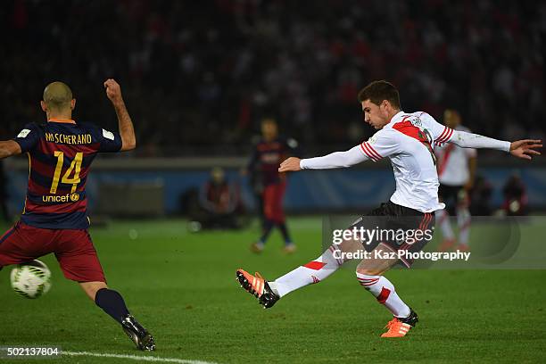 Lucas Alario of River Plate shoots the ball unde the pressure from Javier Mascherano of FC Barcelona during the FIFA Club World Cup Final match...