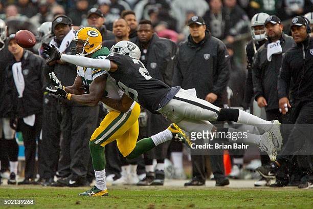 Cornerback David Amerson of the Oakland Raiders knocks away a pass from wide receiver James Jones of the Green Bay Packers in the first half on...