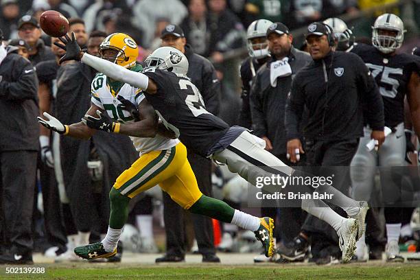 Cornerback David Amerson of the Oakland Raiders knocks away a pass from wide receiver James Jones of the Green Bay Packers in the first half on...