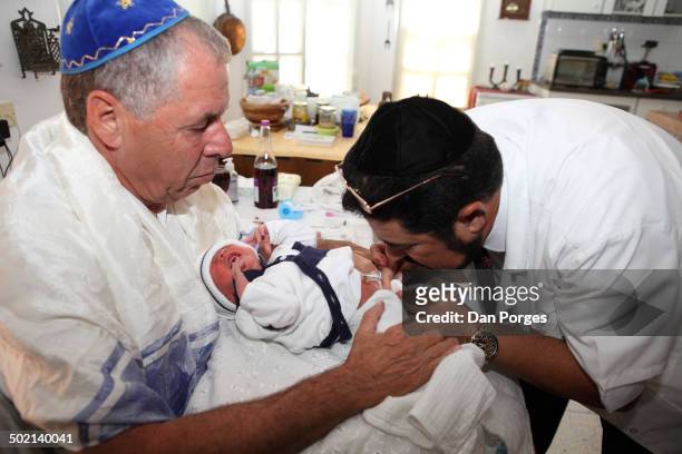 During a brit milah ceremony, a mohel performs metzitzah on an eight-day-old Jewish boy following circumcision, Jerusalem, Israel, July 23, 2012.,...