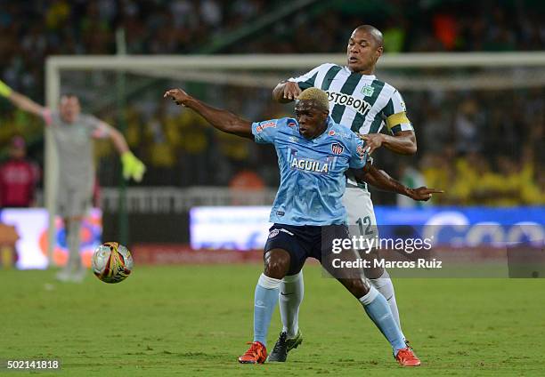 Edison Toloza of Junio struggles for the ball with Alexis Enriquez of Nacional during a second leg final match between Atletico Nacional and Atletico...