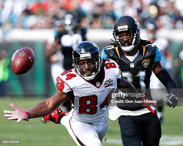 Wide Receiver Roddy White of the Atlanta Falcons attempts to make a catch over Cornerback Davon House of the Jacksonville Jaguars during the game at...