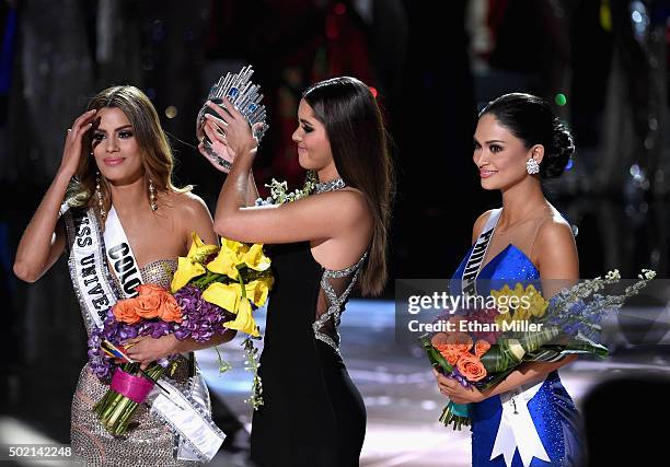 Miss Colombia 2015, Ariadna Gutierrez Arevalo, looks on as Miss Universe 2014 Paulina Vega removes her crown to give it to Miss Phillipines 2015, Pia...