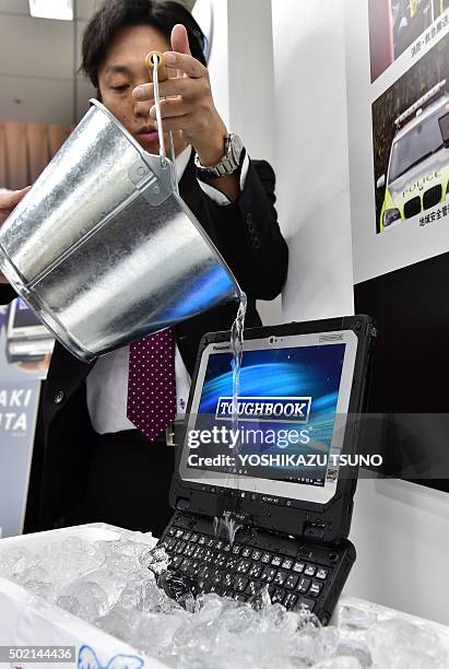 Japan's electronics giant Panasonic employee displays the new heavy duty notebook computer "Toughbook CF-20", which has a detachable display to use...