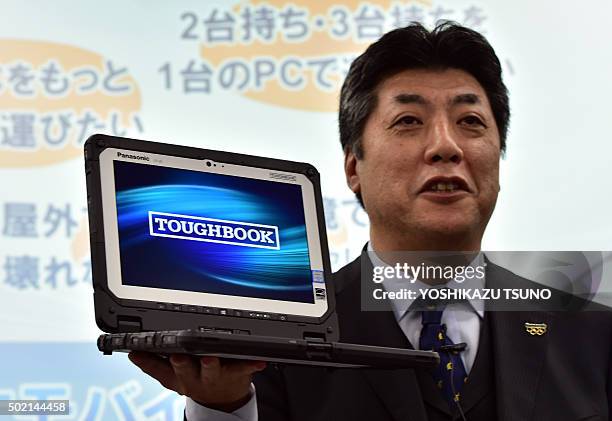 Japan's electronics giant Panasonic executive Hiroaki Sakamoto displays the new heavy duty notebook computer "Toughbook CF-20", which has a...